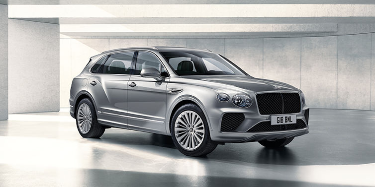 Bentley Jakarta Bentley Bentayga Extended Wheelbase SUV front three quarter in Moonbeam paint with a grey background